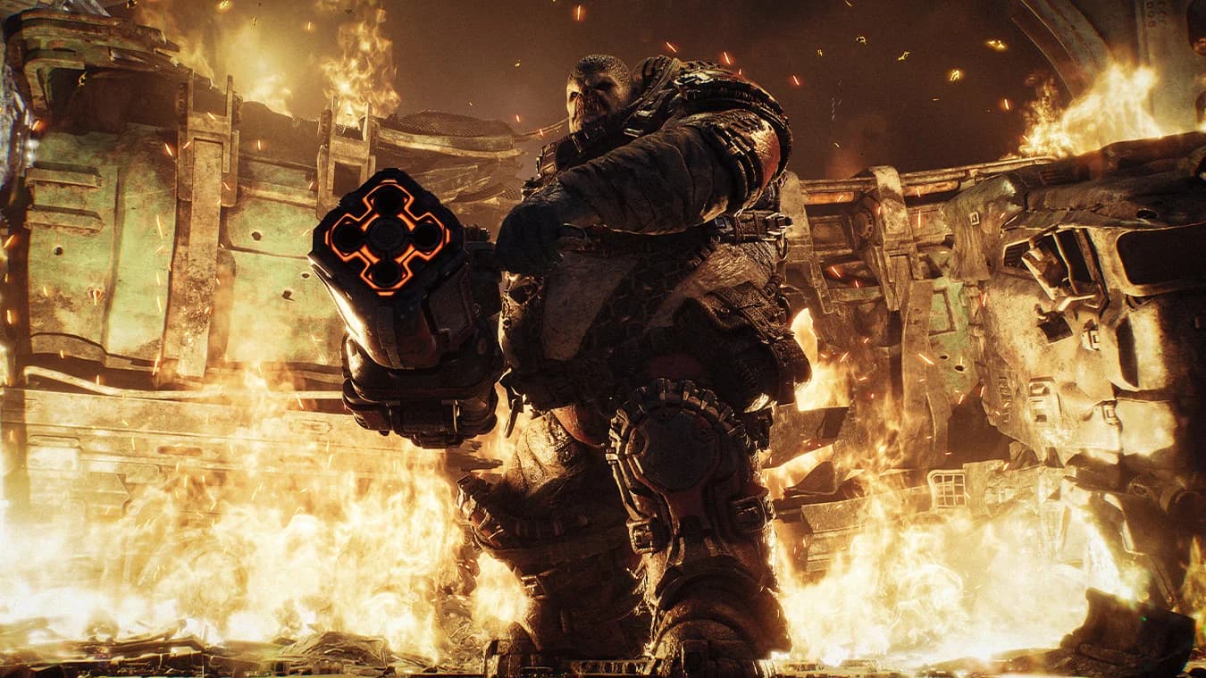 A heavily armed Boomer surrounded by fire and rubble in E-Day